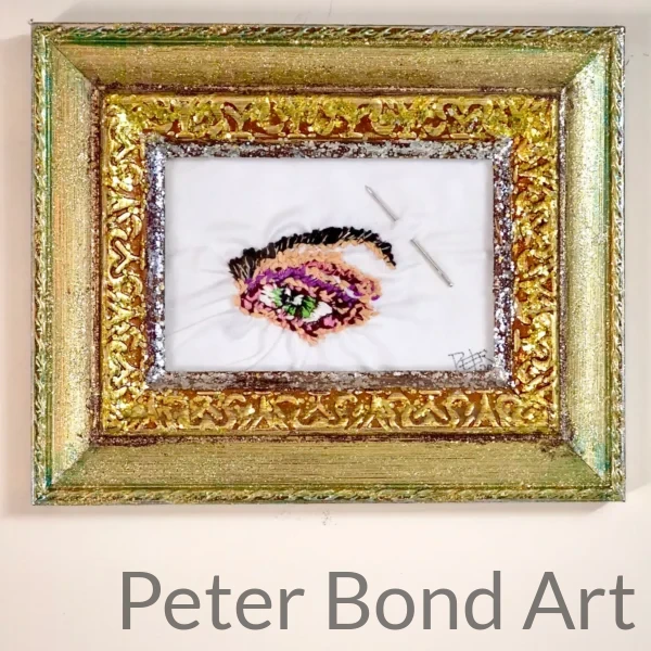 framed needlepoint green eye